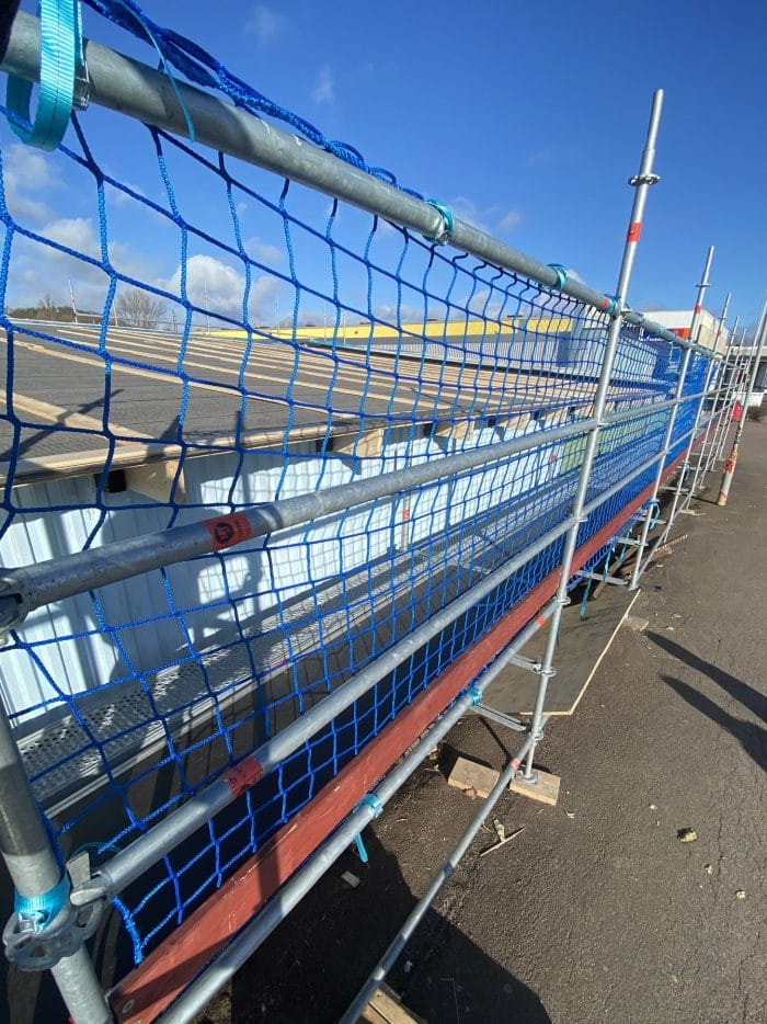 Scaffolding net. Guardrail netting that is placed on the scaffold railing.