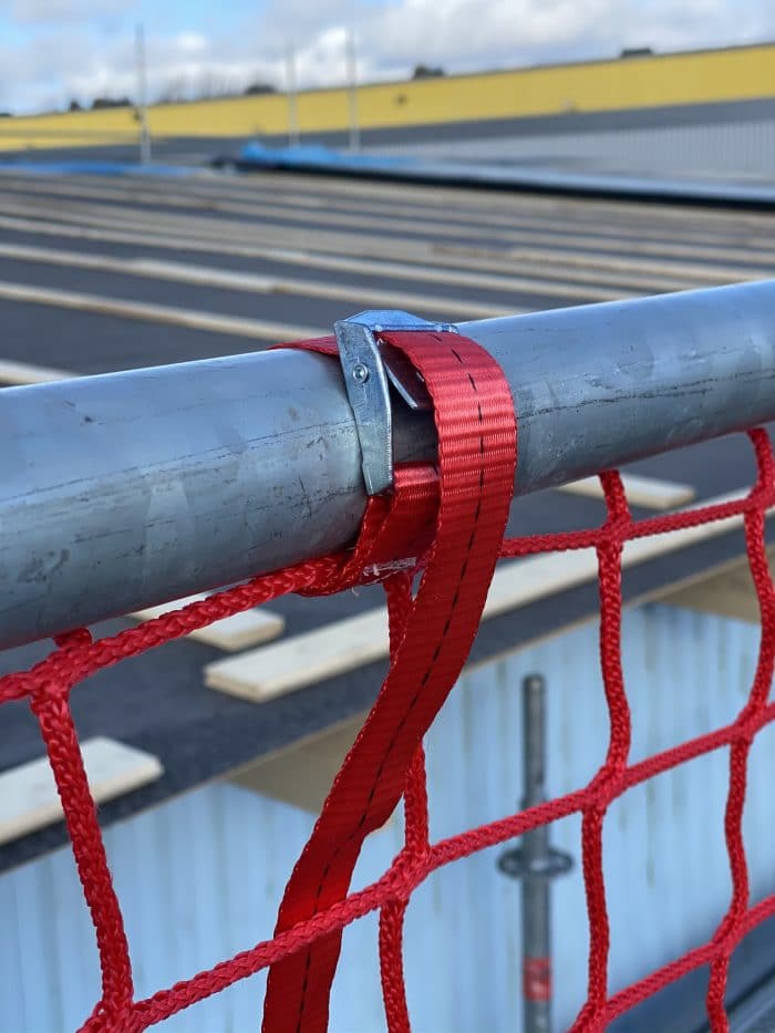 Red safety net. Scaffolding net for scaffolding