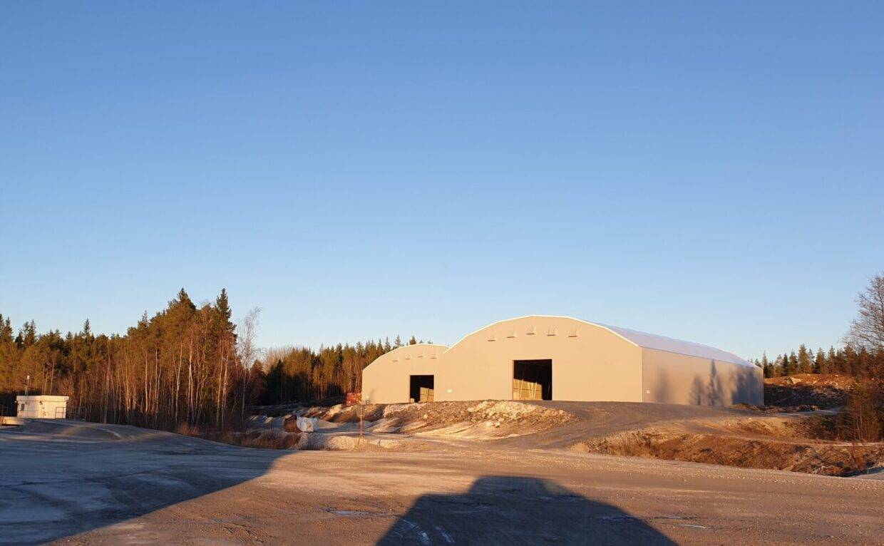 Two grey fabric structures for storing limestone at SMA Mineral